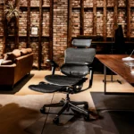 rgohuman Leather Black chair with foldable mesh legrest, 5D armrests, adjustable lumbar support and polished aluminum frame.