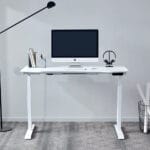 Full view of the height adjustable desk setup featuring a laptop on the tabletop, illustrating an ergonomic and modern workspace designed for comfort and efficiency